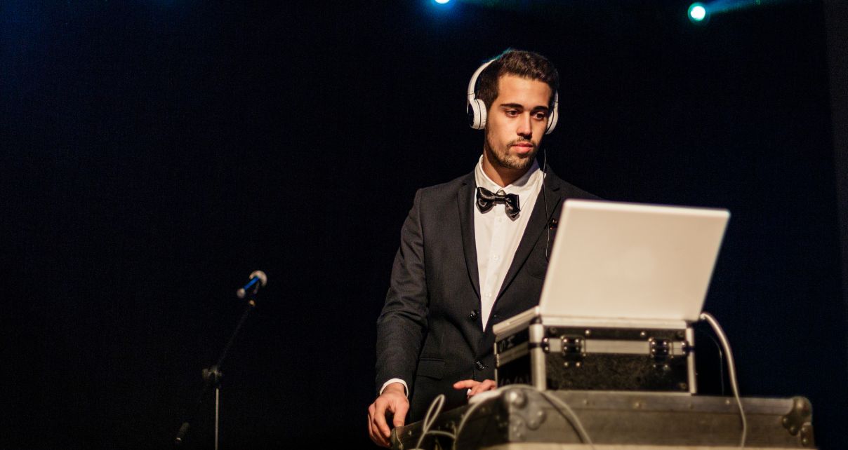 Wedding DJ in tuxedo reads the dancefloor