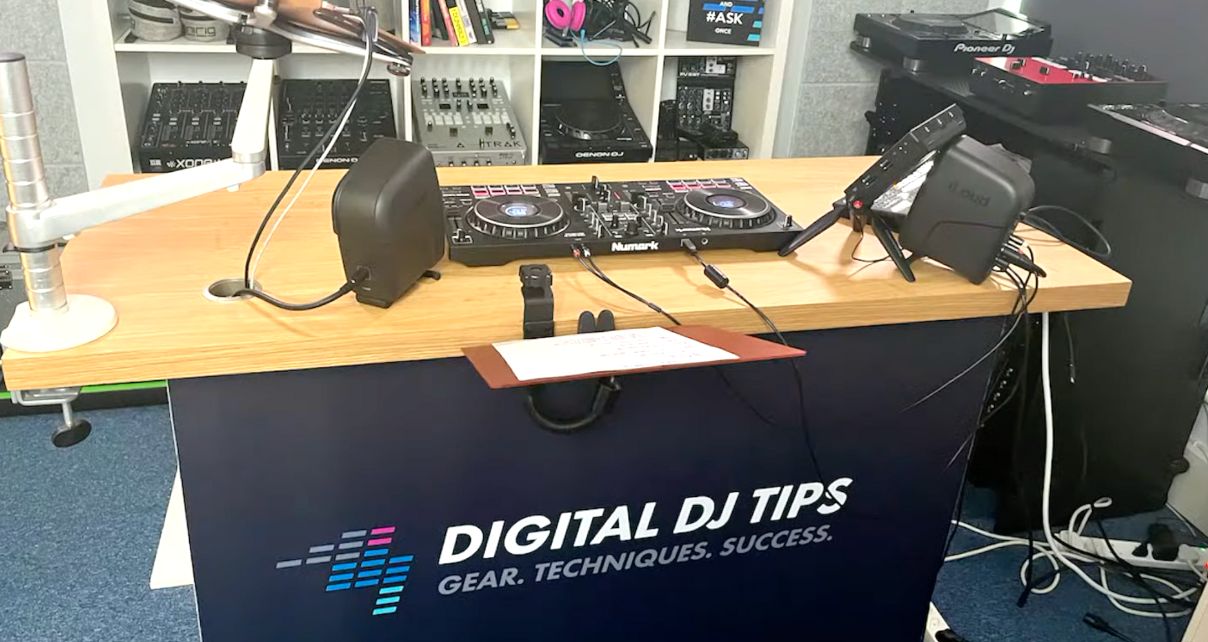 Front view of the desk in the Digital DJ Tips studio featuring a branded logo